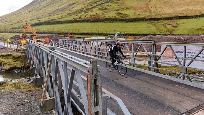 Cyclist riding on a temporary bridge
